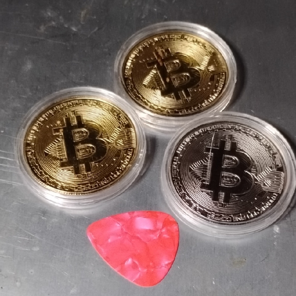 Gold and Silver Bitcoin Coins with Red Guitar Pick